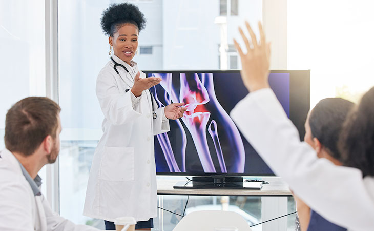 doctor woman talking to students