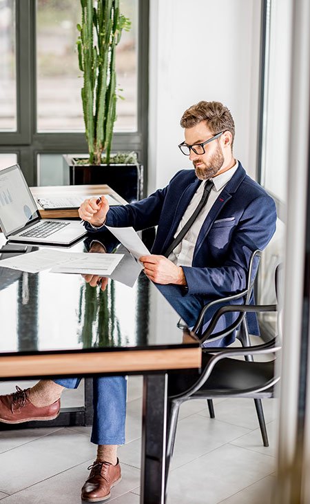 100+ Interview Questions For Product Managers + Answers Independent Recruiter LLC | Staffing Agency man-suit-looking-papers-table