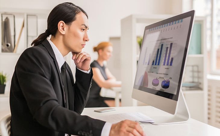 a thoughtful businessman looking at his computer